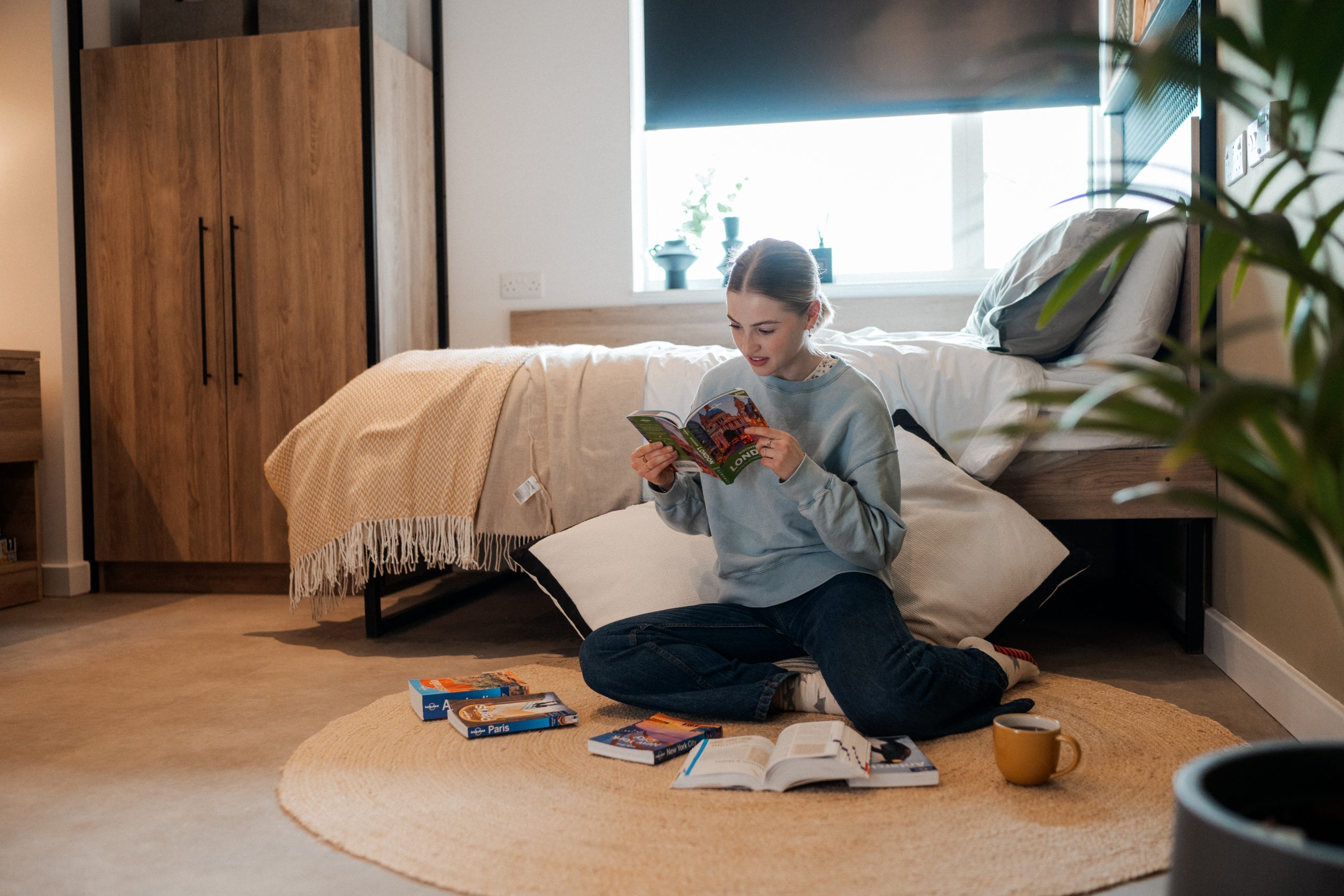 Student reading books on the floor