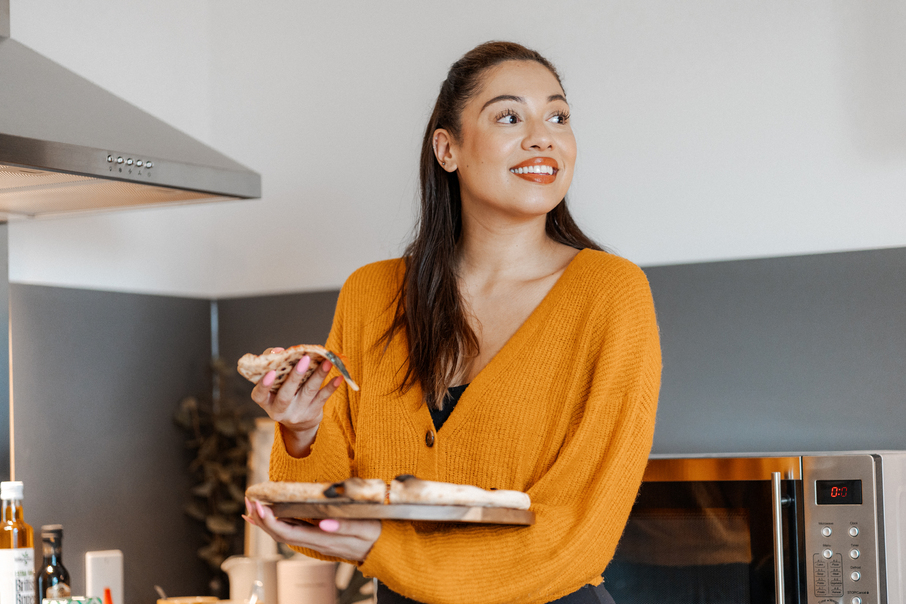 Student eating a slice of pizza