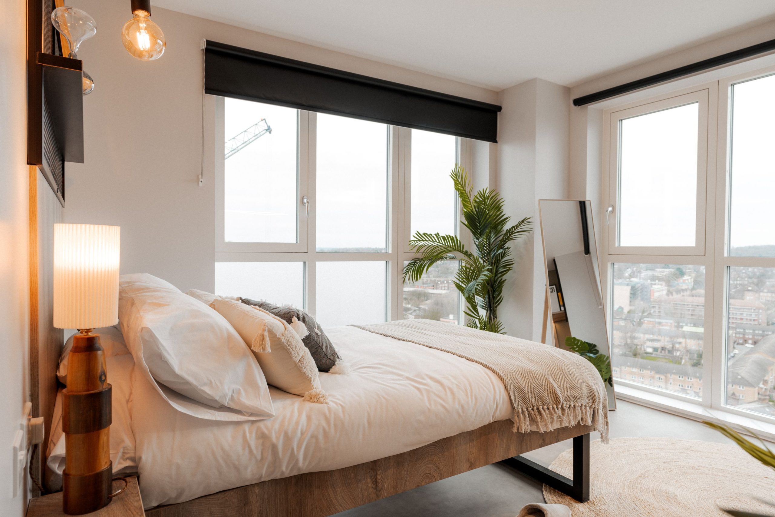 Cream student accommodation room with glass views and bed