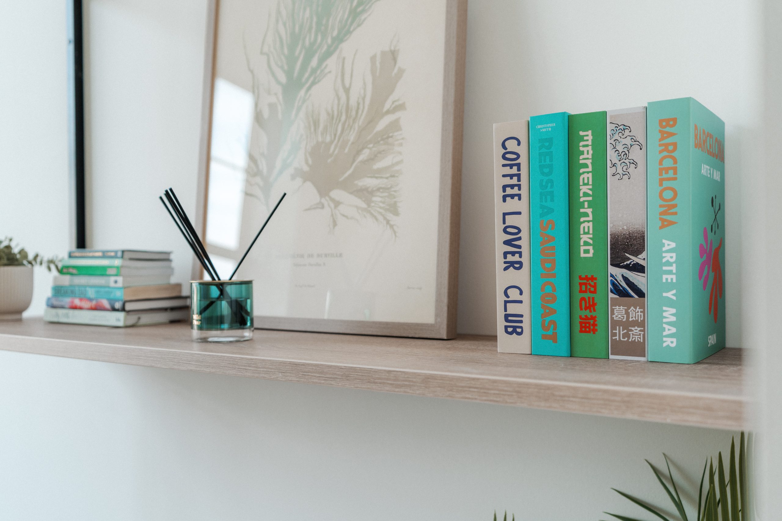 Shelf inside student accommodation room with diffuser and stack of books
