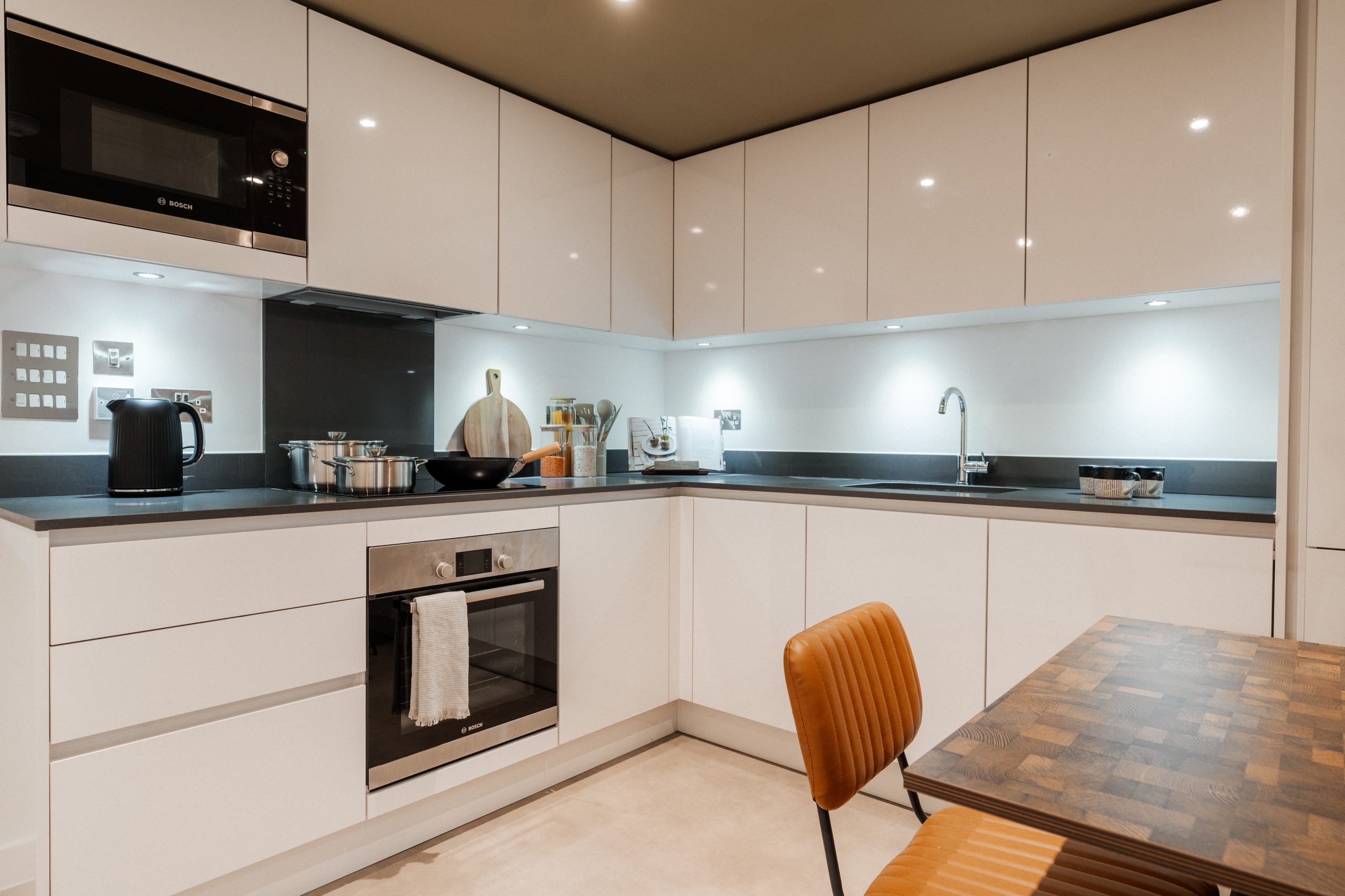 Kitchen inside student accommodation with dining table, kettle, oven and sink