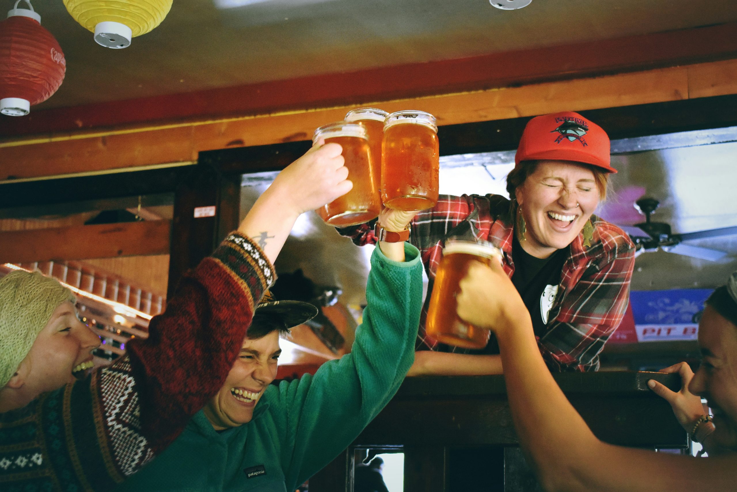 Students clinking pints together