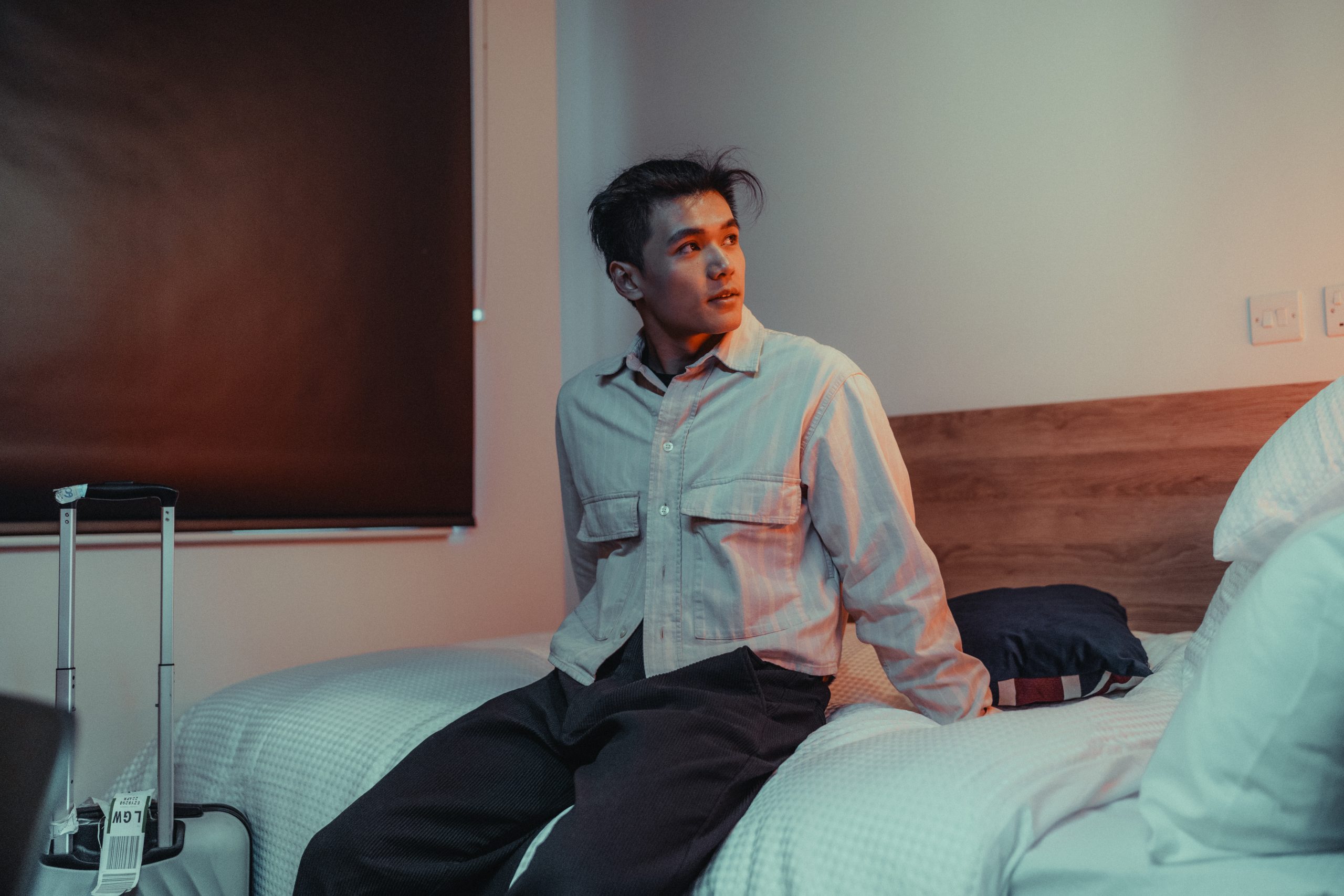 Student sits on his bed