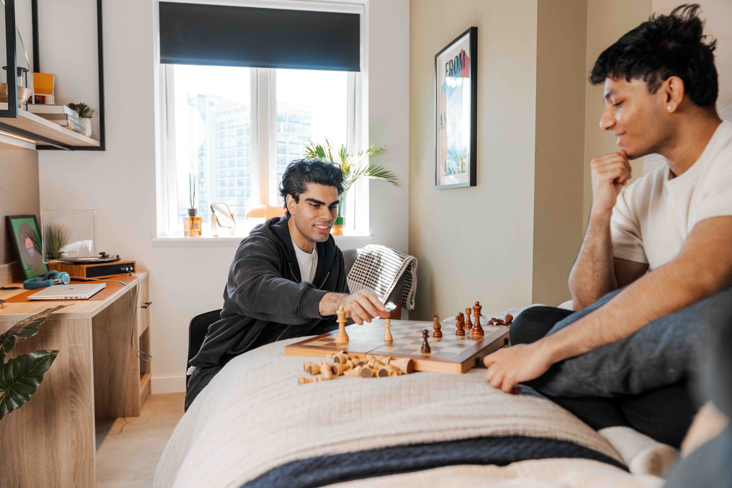 Students playing chess in their room