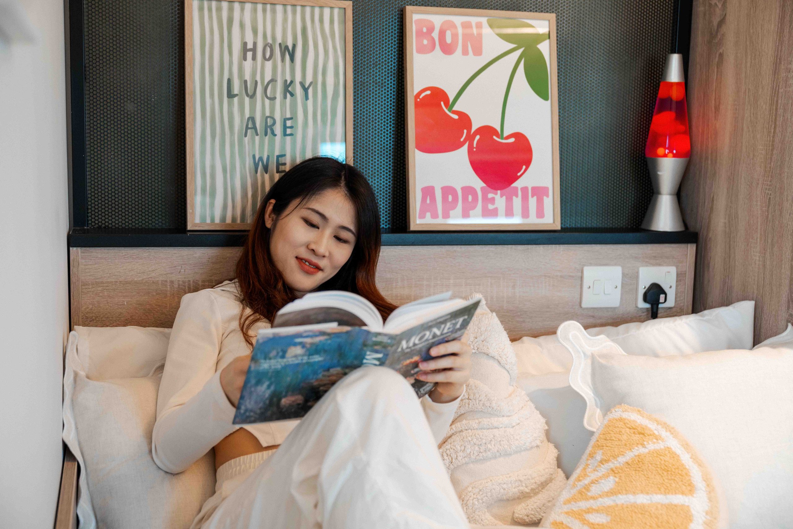 Student reading her book under art