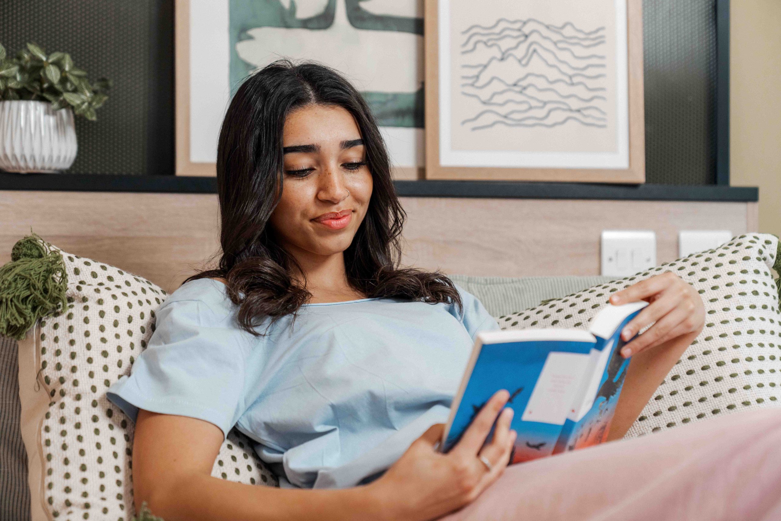 Student reading in her bed
